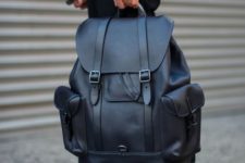 an oversized black leather backpack with pockets and straps is always a stylish idea