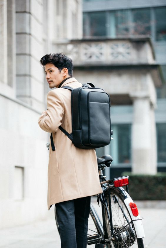 an ultra-minimalist black leather backpack is a cool accessory for modern outfits