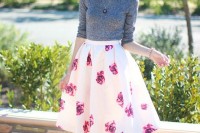 a grey top over a white shirt, a bright floral A-line midi skirt, nude shoes for a retro-infused spring outfit