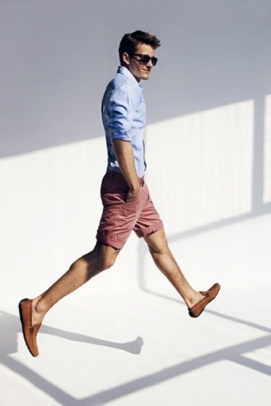 a blue shirt with cuffed sleeves, coral shorts and mustard suede moccasins for a relaxed look on a hot day