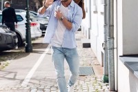 a white top, a blue shirt, blue jeans and white sneakers plsu a brown bag for a comfy outfit