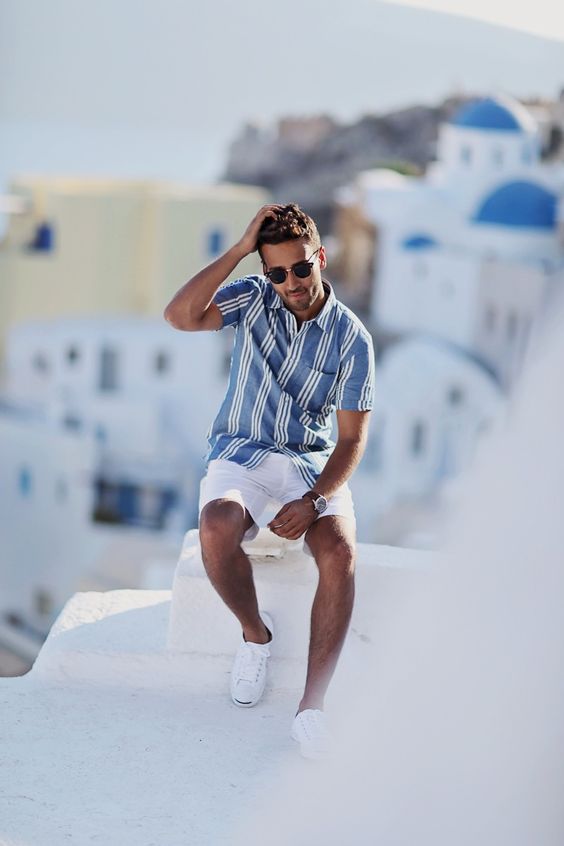 a blue striped short sleeve shirt, white shorts, white sneakers are a classic coastal look