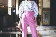 a bold outfit with pink high waisted pants, teal shoes, a polka dot blouse and a clutch