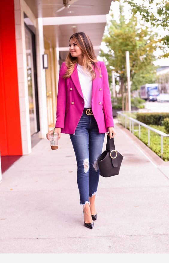 a bright work outfit with a hot pink blazer, a white tee, navy ripped jeans, black shoes and a black bag
