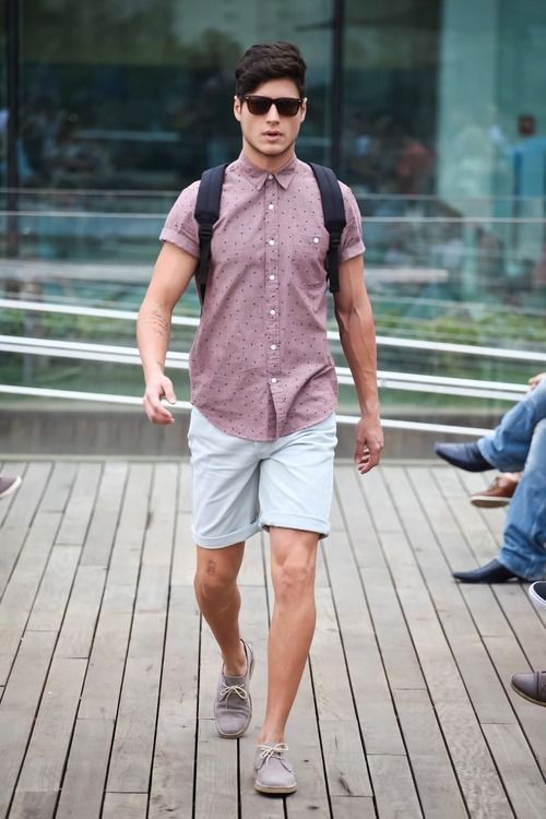 a mauve printed short sleeve shirt, off-white shorts, gren suede shoes and a backpack