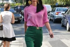 a pink shirt, green pants and statement earrings for a colorful spring work look