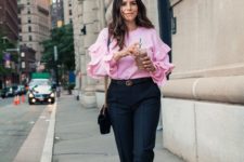 a pink shirt with ruffle sleeves, black pants, black bow shoes and a bag for a girlish touch