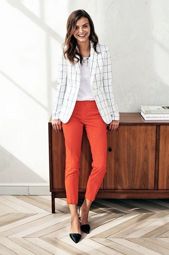 a white tee, a windowpane blazer, rust cropped pants, black flat shoes and a necklace