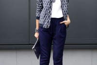a white tee, navy pants, a printed blazer, statement necklaces and blue printed heels and a clutch