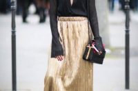Trendy look with black blouse and golden skirt