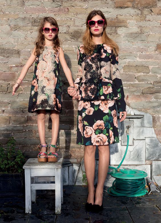 floral suit and a matching floral dress with red framed sunglasses