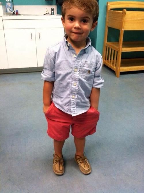 red shorts, a chambray shirt and shoes