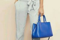 19 grey pants with a bow and a white shirt with an accent purse
