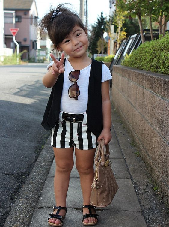 monochromatic outfit with shorts and a black vest