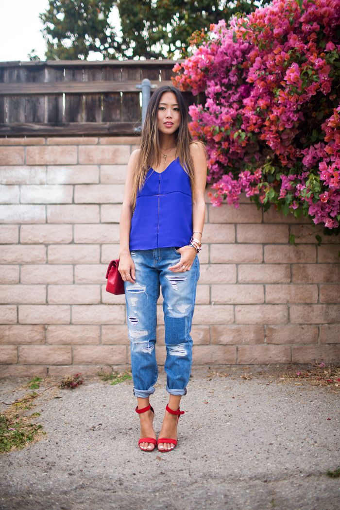disressed jeans, blue top and red shoes