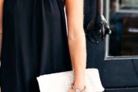 Simple black halter dress with white clutch