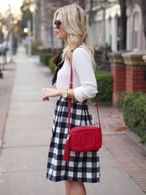 Stylish look with checked skirt, white blouse and red mini bag