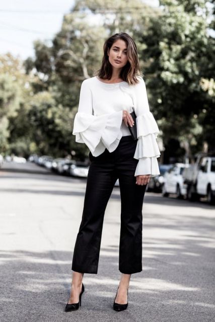 White blouse with ruffle sleeves and black pants