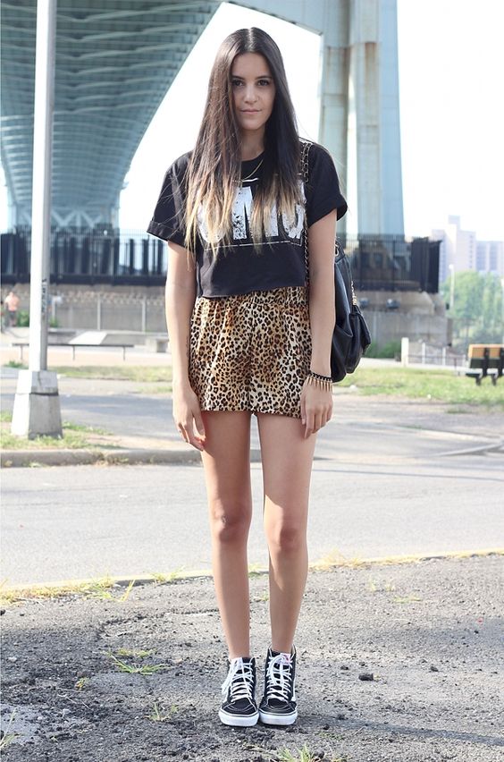 animal-print shorts and a printed tee with black Vans
