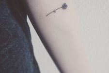 02 black flower tattoo on an arm