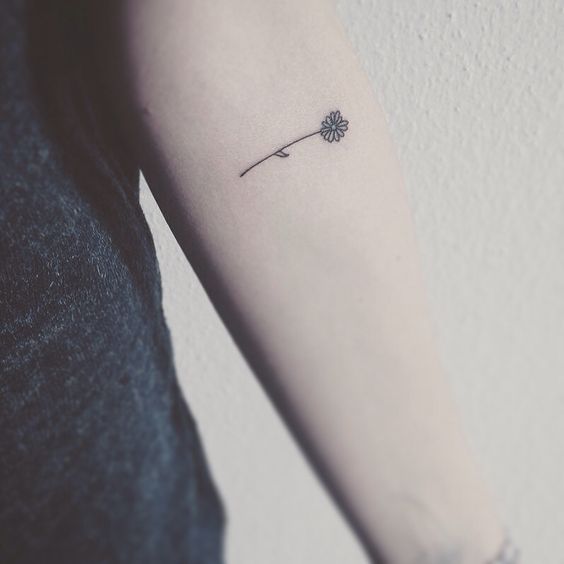 black flower tattoo on an arm