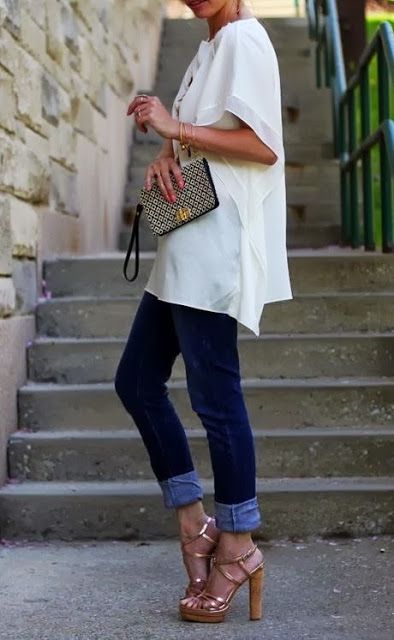 an oversized high-low top, navy jeans and high heels