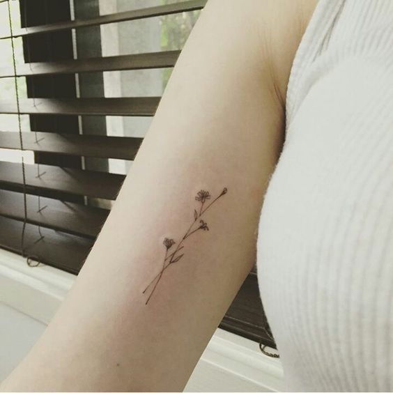 tiny wildflower arm tattoo