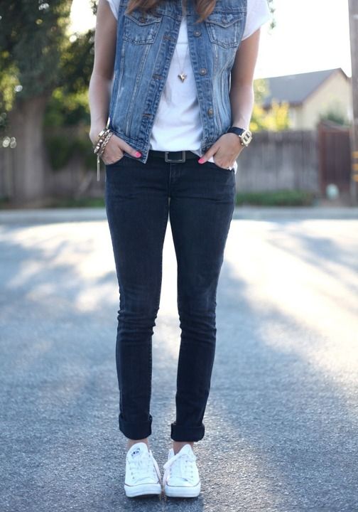 black jeans, a white tee, a denim vest and white Converse