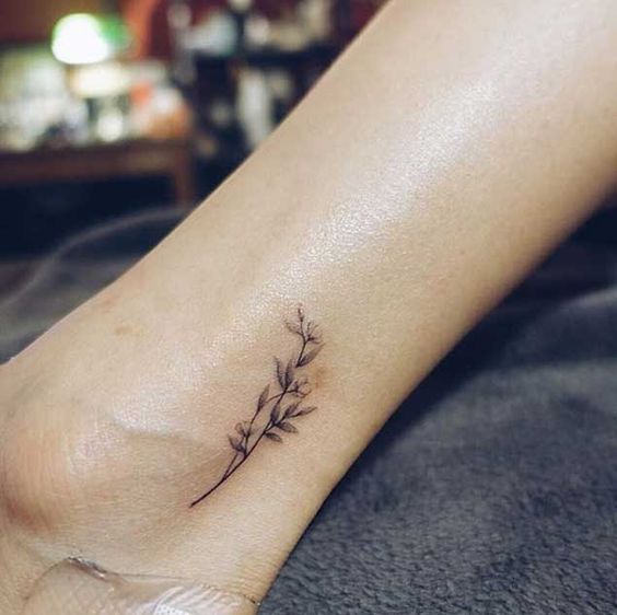 tiny ankle black flower tattoo