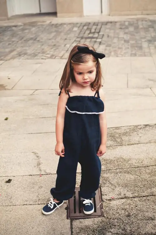 navy ruffled sunsuit with navy sneakers