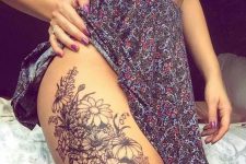 17 black flower thigh tattoo
