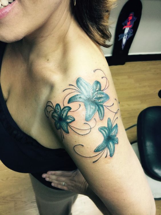 green lilies on an arm