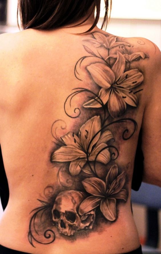 blackwork lily and skull back tattoo