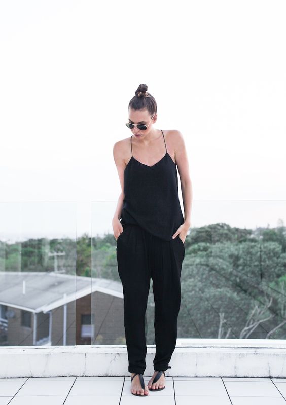 black pants, a black spaghetti strap top and sandals
