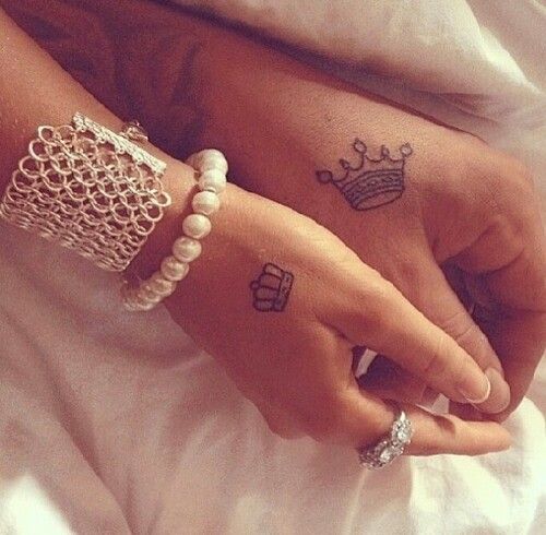 matching couple crown tattoos on hands