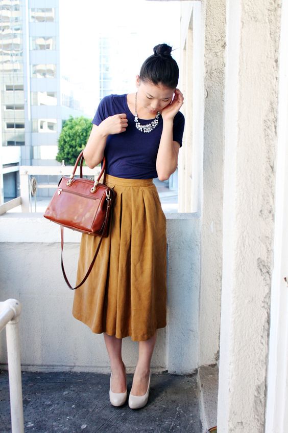 yellow midi, a navy tee, white shoes and a statement necklace