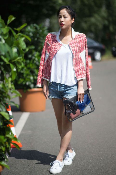 denim shorts, a white tee, a red jacket and white sneakers