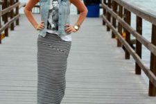 Relaxed look with denim vest, t-shirt and striped maxi skirt