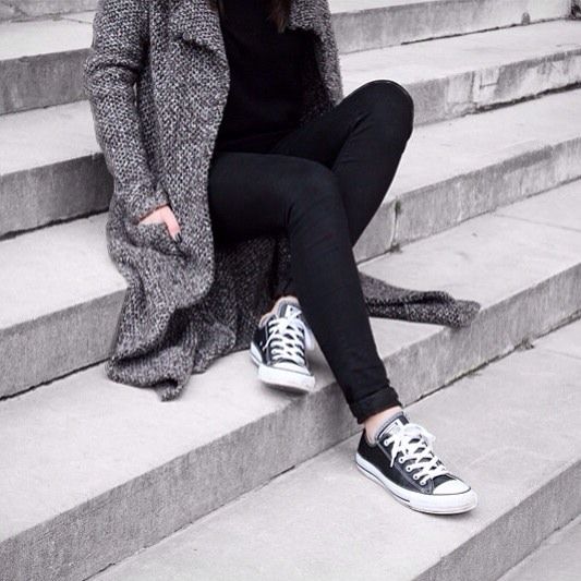 black jeans, a black sweater and a grey cardigan