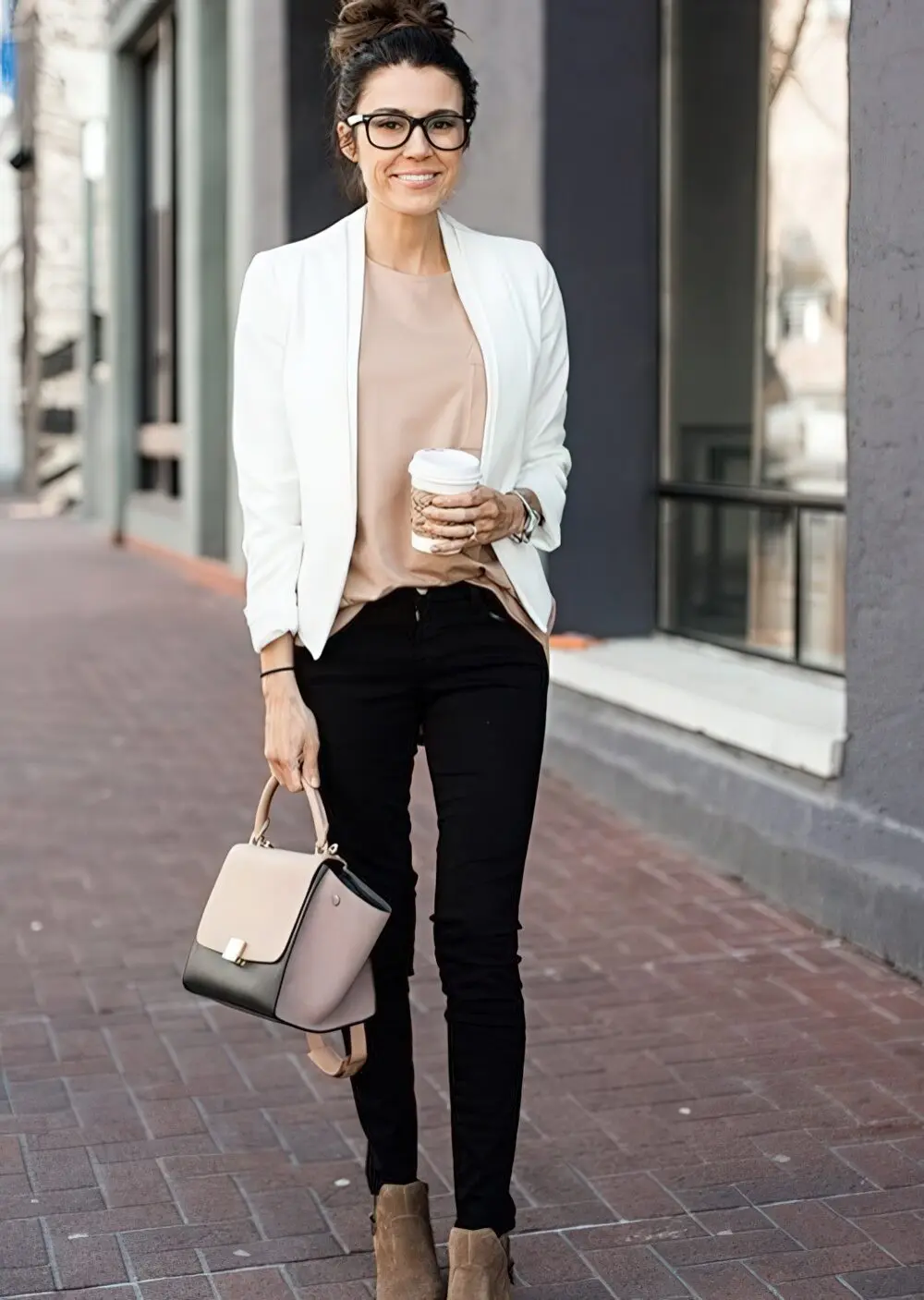 Black jeans, a blush top, a white blazer and tan suede boots.