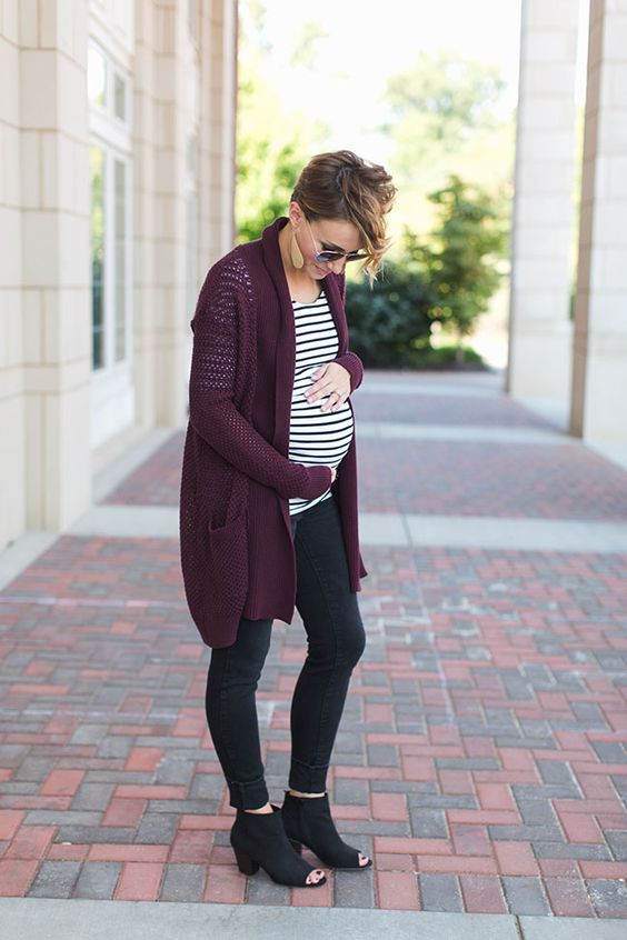 black jeans, black cutout boots, a striped shirt and a purple cardigan