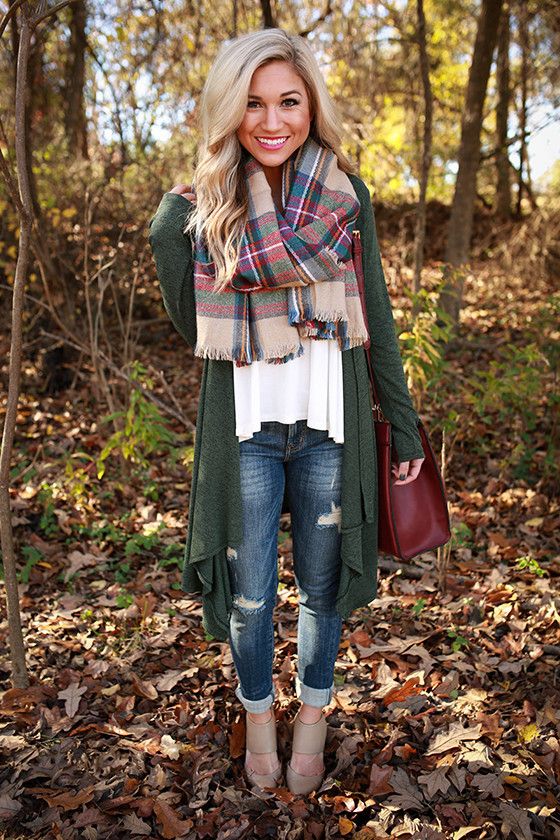 an oversized green cardigan, a white top and a plaid blanket scarf