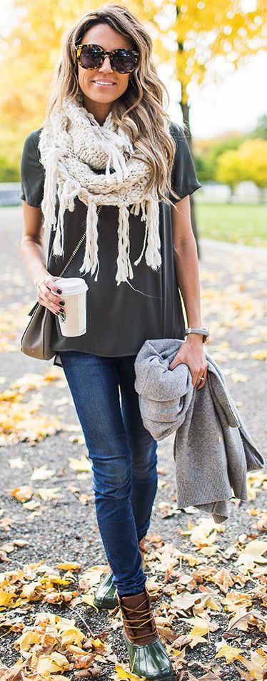 grey tee, blue jeans, a white fringe scarf