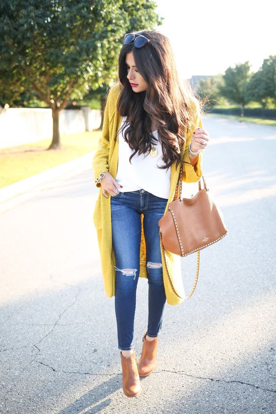 long mustrad cardigan, ripped jeans, a white blouse and brown ankle boots