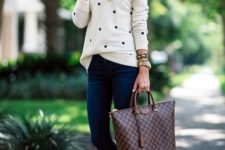12 navy jeans, a dotted white jersey and brown boots and a bag