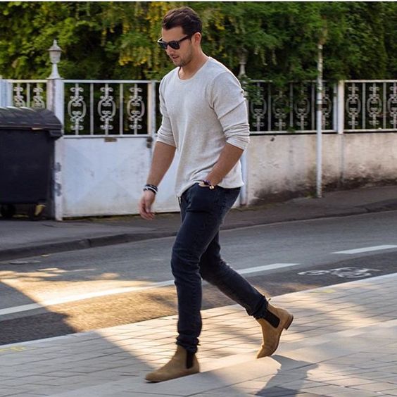 navy jeans, a white long-sleeve and ocher boots