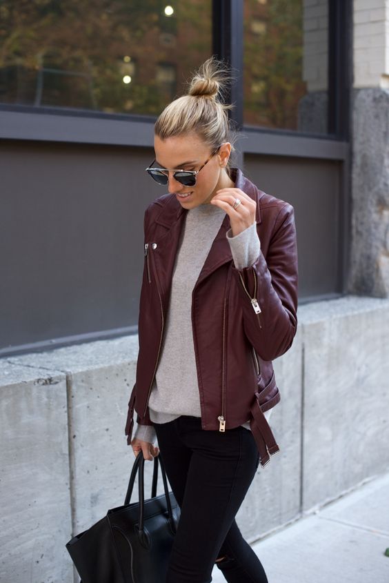 black jeans, a grey tee and a burgundy leather jacket
