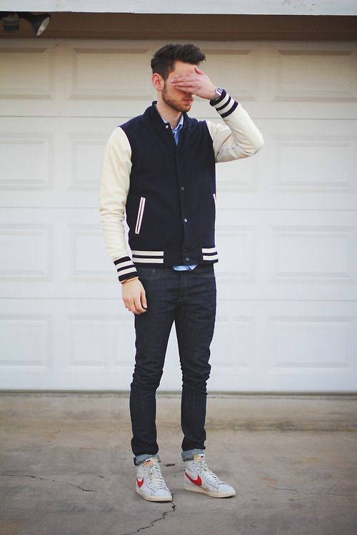 navy jeans, a navy and beige jacket and chucks