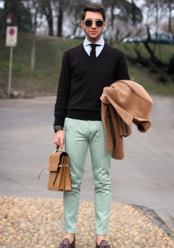 mint trousers, a black sweater and tie, a camel coat