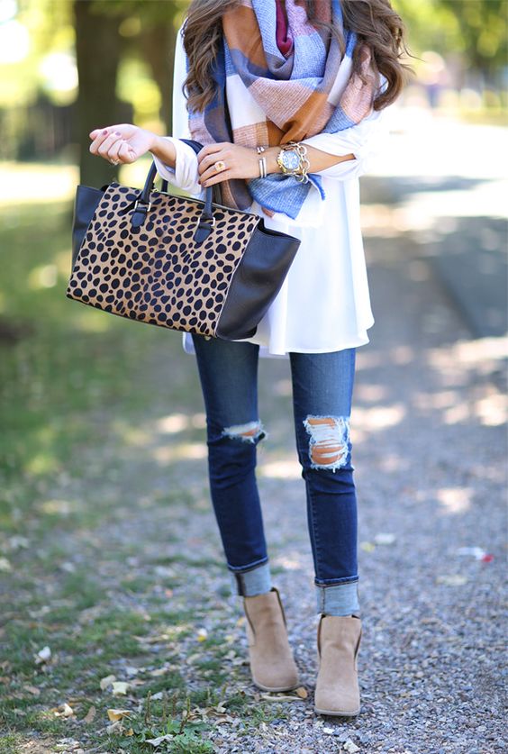 ripped jeans, a white shirt and a blanket scarf